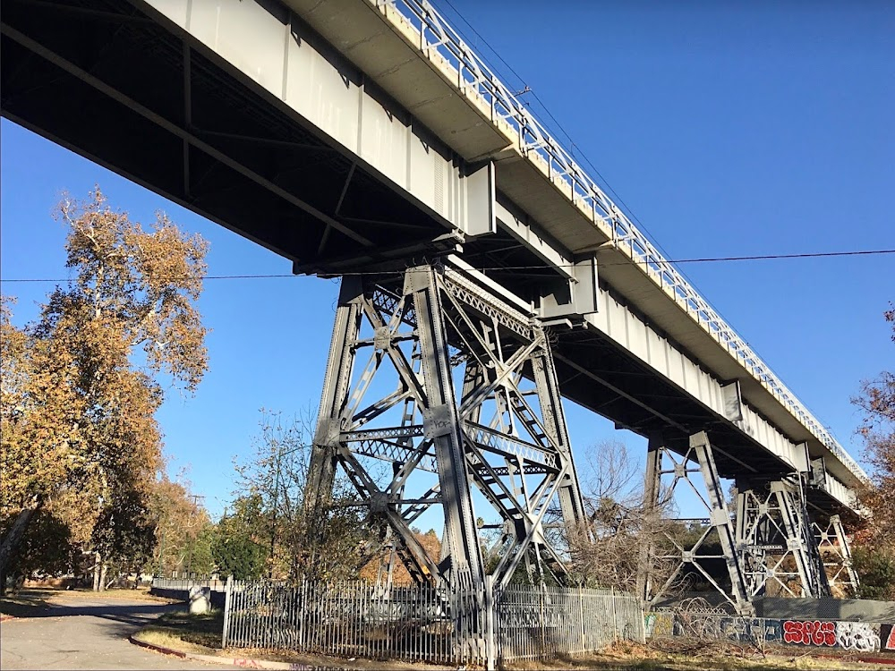 Red Steel : Scene passing industrial bridge and train tracks, specifically the eastern side of park along the Los Angeles River.