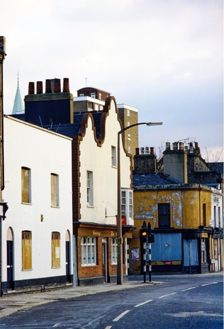 The Man in the White Suit : yard shots of the arch and exteriour of building and where he sits in the road