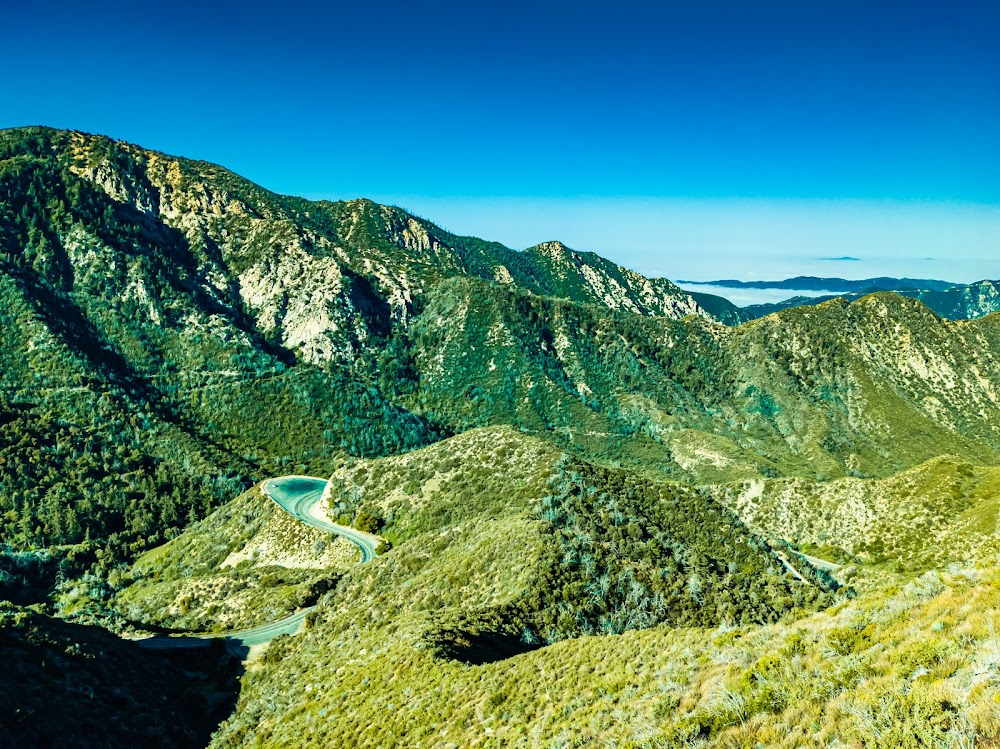 Impact : driving mountain road past a substantial retaining wall with precipitous drop