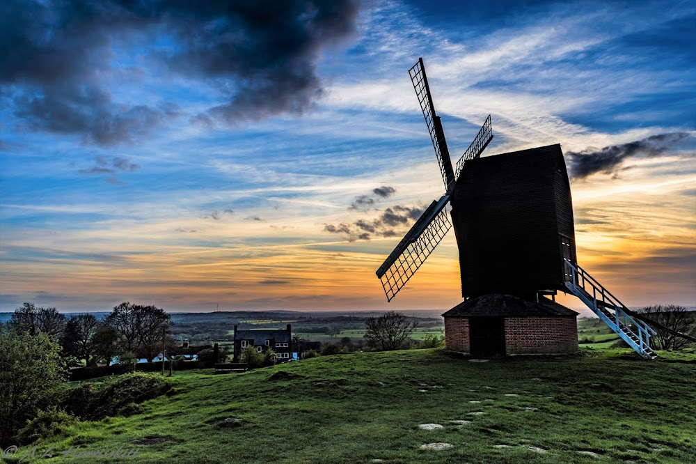 Longitude : John Harrison tests his chronometer in a boat in the sea overlooked by a windmill