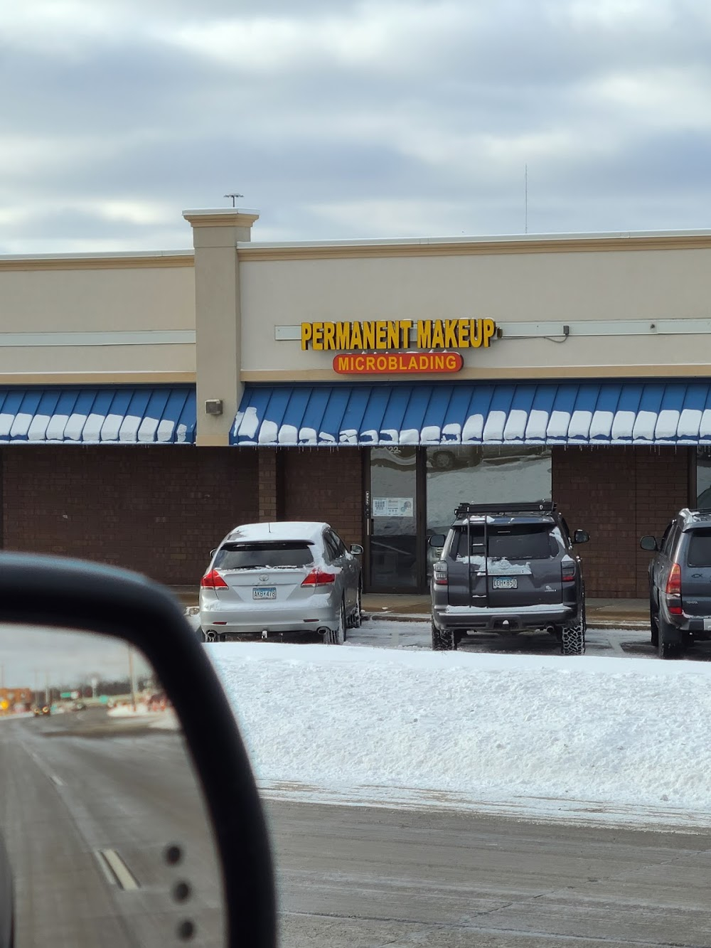 Los Enchiladas! : Sarah & Amy in car parked at the building's northeast corner, which was partially demolished in 2017 to make room for a Chick-fil-A.