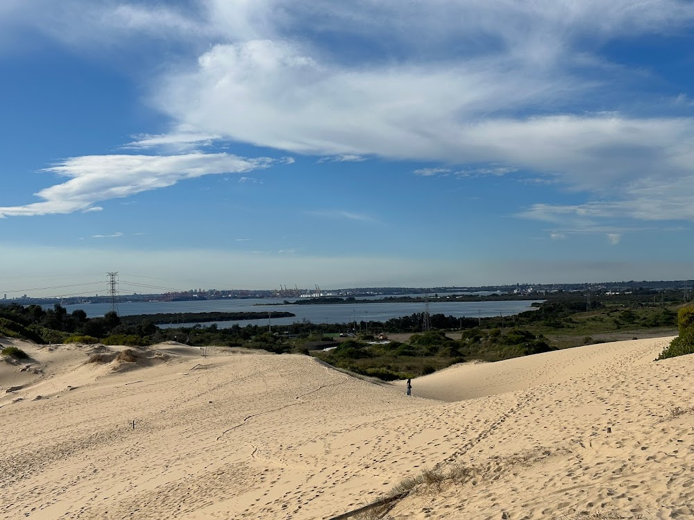 The Back of Beyond : two girls running across sand dunes