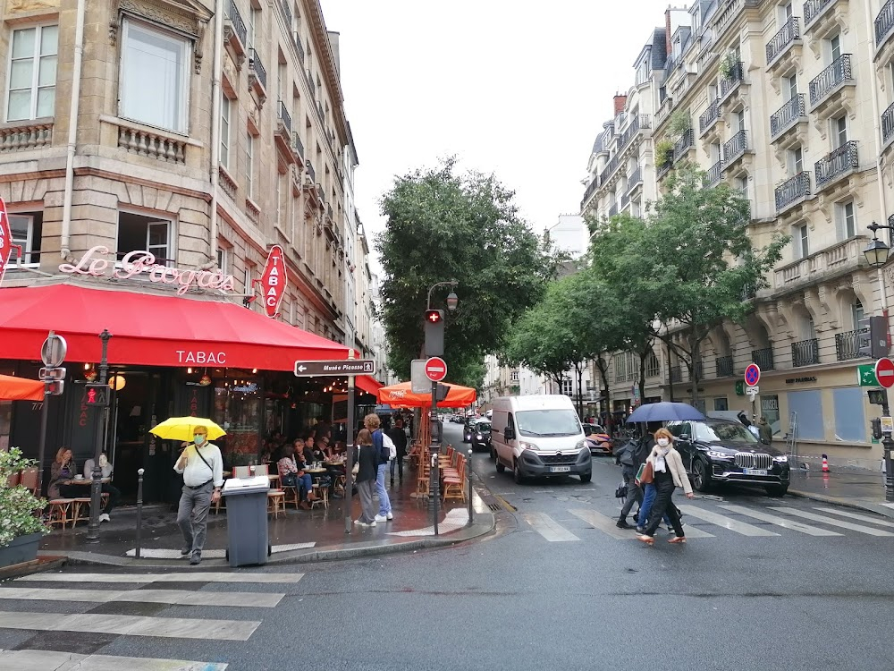 Monique : Alex walks down a street and strops outside a bar-tobacconist shop