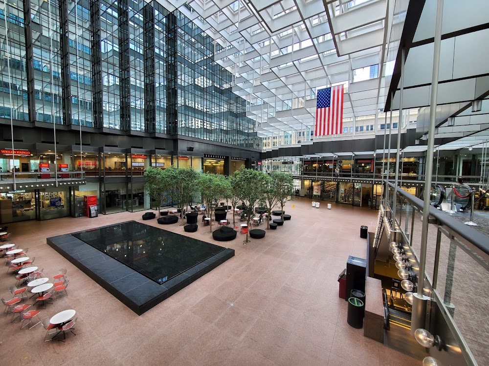 Just Be There : Frank's office; Mitchell and Carol ride down the escalator