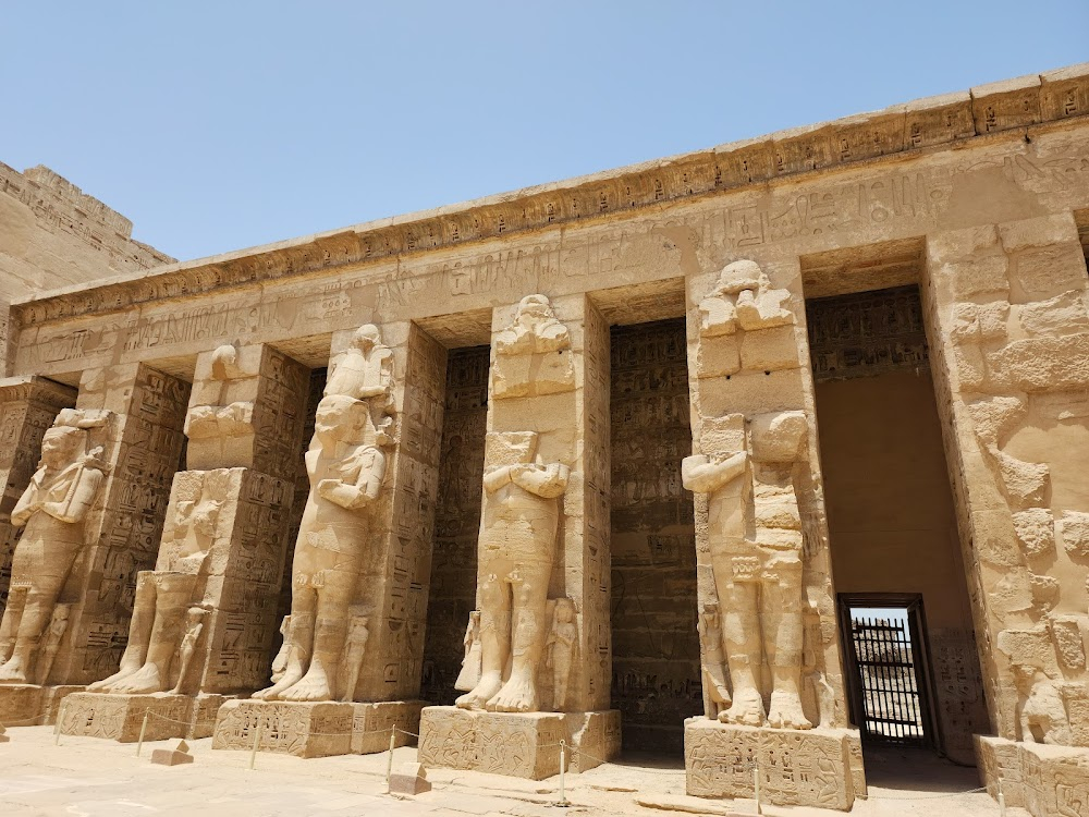 Cairo : as Ali runs to his dry farmland, the Mortuary Temple of Ramesses III is in the background